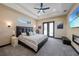 Luxurious main bedroom featuring a tray ceiling, fireplace, and double doors to the outdoor living area at 8312 Acorn Blvd, Punta Gorda, FL 33982