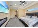 Comfortable main bedroom featuring a tray ceiling, fireplace, and access to the ensuite bathroom at 8312 Acorn Blvd, Punta Gorda, FL 33982