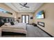 Spacious main bedroom showcasing a fireplace, tray ceiling, and plush gray carpet throughout at 8312 Acorn Blvd, Punta Gorda, FL 33982