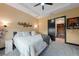 Comfortable main bedroom offering a ceiling fan, cozy decor, and convenient access to the closet at 8312 Acorn Blvd, Punta Gorda, FL 33982