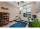 Comfortable office with a large window, a cozy chair, and wood flooring illuminated by natural light at 8312 Acorn Blvd, Punta Gorda, FL 33982