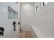 Luxurious walk-in shower featuring elegant tile and a built-in shower seat at 8312 Acorn Blvd, Punta Gorda, FL 33982