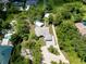 An aerial view of the property showcasing its expansive lot, detached garage and mature landscaping at 875 Bayshore Dr, Englewood, FL 34223