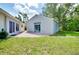 Backyard with lush lawn and patio, perfect for entertaining at 875 Bayshore Dr, Englewood, FL 34223
