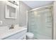 Bathroom features a glass-enclosed shower, modern vanity, and updated fixtures at 875 Bayshore Dr, Englewood, FL 34223