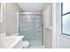Bathroom with glass-enclosed shower, white tiling, and a modern vanity at 875 Bayshore Dr, Englewood, FL 34223