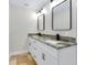 Bathroom vanity with double sinks, granite countertop and modern black fixtures and hardware at 875 Bayshore Dr, Englewood, FL 34223