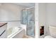 A luxurious bathroom featuring a jetted tub and a separate shower with decorative etched glass at 875 Bayshore Dr, Englewood, FL 34223