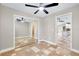 Bedroom with modern ceiling fan, sliding mirror closet doors and an ensuite bathroom at 875 Bayshore Dr, Englewood, FL 34223