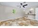 Bedroom featuring tile flooring, a ceiling fan, and a large window offering outdoor views at 875 Bayshore Dr, Englewood, FL 34223