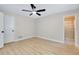 Bright bedroom features ceiling fan, neutral paint, and an adjacent bathroom with tiled shower at 875 Bayshore Dr, Englewood, FL 34223