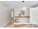 Bedroom featuring tile flooring, a shelf with decor, and a door to the right at 875 Bayshore Dr, Englewood, FL 34223