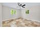 Bedroom with tile floors, a ceiling fan and natural light from two windows at 875 Bayshore Dr, Englewood, FL 34223