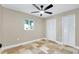 Bedroom featuring neutral colors, two closets, a window and a modern ceiling fan at 875 Bayshore Dr, Englewood, FL 34223