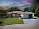 Charming single-story home with a well-maintained lawn and attached garage at 875 Bayshore Dr, Englewood, FL 34223