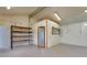 Garage interior with roll-up door, concrete floors, ample lighting, utility connections, and shelves at 875 Bayshore Dr, Englewood, FL 34223