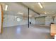 Spacious garage interior with roll-up door, concrete floors, ample lighting, and utility connections at 875 Bayshore Dr, Englewood, FL 34223