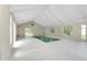 Bright indoor pool area with a minimalist design, white walls, and multiple windows offering natural light at 875 Bayshore Dr, Englewood, FL 34223