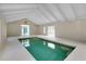 Indoor pool area with high ceilings and natural light, perfect for year-round enjoyment at 875 Bayshore Dr, Englewood, FL 34223