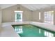 Bright indoor pool area with ample lighting and a clean, modern design at 875 Bayshore Dr, Englewood, FL 34223