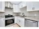This kitchen features white cabinets, stainless steel appliances, and granite countertops at 875 Bayshore Dr, Englewood, FL 34223