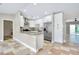 Updated kitchen featuring white cabinets, granite countertops, and stainless steel appliances at 875 Bayshore Dr, Englewood, FL 34223