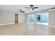 Spacious living room with hardwood floors, ceiling fans, and sliding glass doors to the exterior at 875 Bayshore Dr, Englewood, FL 34223