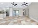 Open-concept living space with tile flooring and access to the kitchen and outdoor area at 875 Bayshore Dr, Englewood, FL 34223