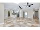 Spacious open-concept layout with tile flooring, kitchen access, and neutral tones throughout at 875 Bayshore Dr, Englewood, FL 34223
