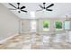 Bright living area boasts tile floors, skylight, ceiling fans, and open access to the kitchen at 875 Bayshore Dr, Englewood, FL 34223