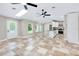 Bright living area boasts tile floors, skylight, ceiling fans, and open access to the kitchen at 875 Bayshore Dr, Englewood, FL 34223