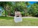 Outdoor grill with an open design, a sturdy concrete base, and sits on a grass lawn at 875 Bayshore Dr, Englewood, FL 34223