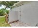 Enclosed outdoor shower area with brick pavers at 875 Bayshore Dr, Englewood, FL 34223