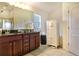 Bathroom features a granite countertop, a large mirror, and a separate tub and shower at 96 Mocha Ct, Punta Gorda, FL 33983