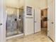 Bright bathroom featuring a glass-enclosed shower with tile surround, and a doorway to another room at 96 Mocha Ct, Punta Gorda, FL 33983