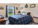 Well-lit bedroom with window and charming nautical decor. Plaid bedding at 96 Mocha Ct, Punta Gorda, FL 33983