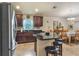 Open concept kitchen with a granite countertop island and seating, dark wood cabinets and stainless steel refrigerator at 96 Mocha Ct, Punta Gorda, FL 33983