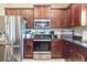 Bright kitchen features stainless steel appliances, dark wood cabinets and granite countertops at 96 Mocha Ct, Punta Gorda, FL 33983