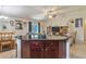 View of the dark wood kitchen island and a view to the living room at 96 Mocha Ct, Punta Gorda, FL 33983