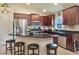 Modern kitchen with stainless steel appliances, dark wood cabinets, and a granite countertop island at 96 Mocha Ct, Punta Gorda, FL 33983