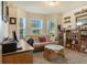 Cozy living room with bright windows, futon, desk and charming decor at 96 Mocha Ct, Punta Gorda, FL 33983
