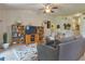 Comfortable living room featuring a cozy couch, wooden shelving, and natural light at 96 Mocha Ct, Punta Gorda, FL 33983