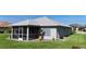 The rear exterior features a screened-in patio, shutters, and landscaped garden beds providing a tranquil outdoor space at 96 Mocha Ct, Punta Gorda, FL 33983