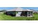 The exterior reveals a screened-in patio, security shutters, and tasteful landscaping, blending comfort with security at 96 Mocha Ct, Punta Gorda, FL 33983