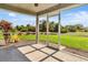 Relaxing screened porch with view of landscaped yard and tropical plants at 96 Mocha Ct, Punta Gorda, FL 33983