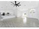 Bright, open living area with modern lighting, tile flooring, and a view of the kitchen at 10055 Franklin Dr, Englewood, FL 34224