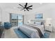 Bedroom with tray ceilings, ceiling fan, and sliding doors to lanai/pool area at 10055 Franklin Dr, Englewood, FL 34224