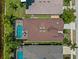 Aerial view of screened in pool, brick patio, and dark roof at 10131 Winding River Rd, Punta Gorda, FL 33950