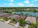 Aerial view of homes near a pond with mature palm trees at 10131 Winding River Rd, Punta Gorda, FL 33950
