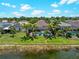 Aerial view of home's backyard with a screened-in pool and lush landscaping at 10131 Winding River Rd, Punta Gorda, FL 33950